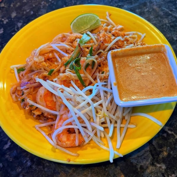 House of Noodle's Pad Thai with shrimp, bean sprouts, lime, and a side of peanut sauce.