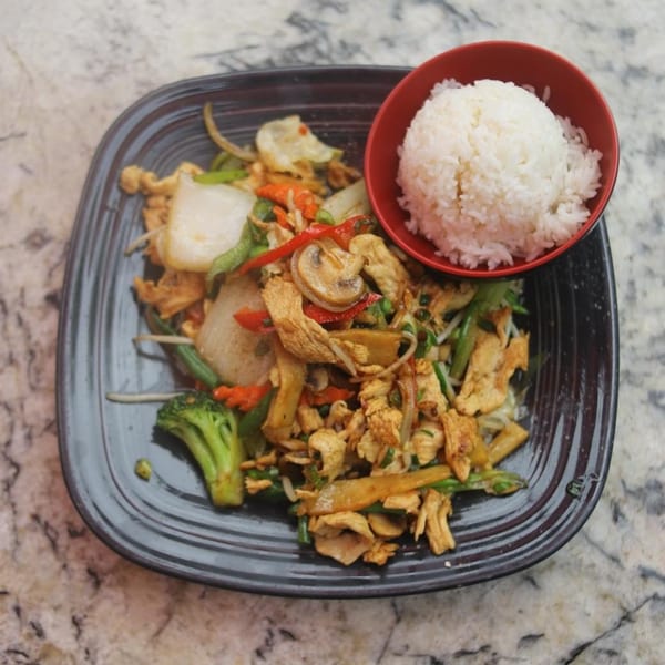A House of Noodle Thai stir-fry with chicken, vegetables, and a side of white rice.
